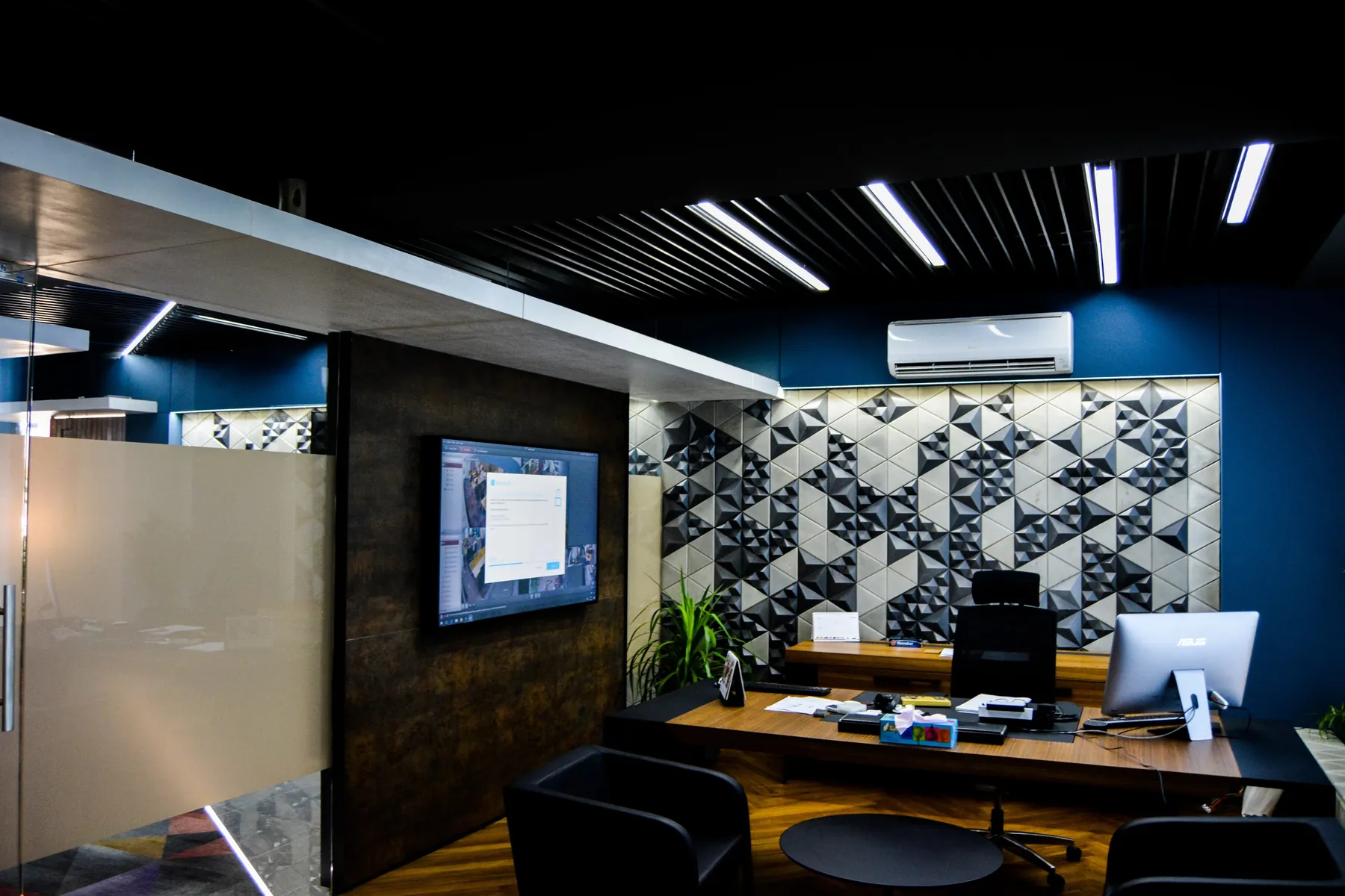 Optium Technologies office with a black and white Mathlath concrete tile feature wall behind the desk