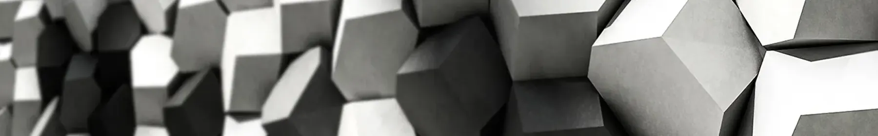 Faceted 3D concrete wall tiles in black, white and grey, each facet catching the light at a different angle