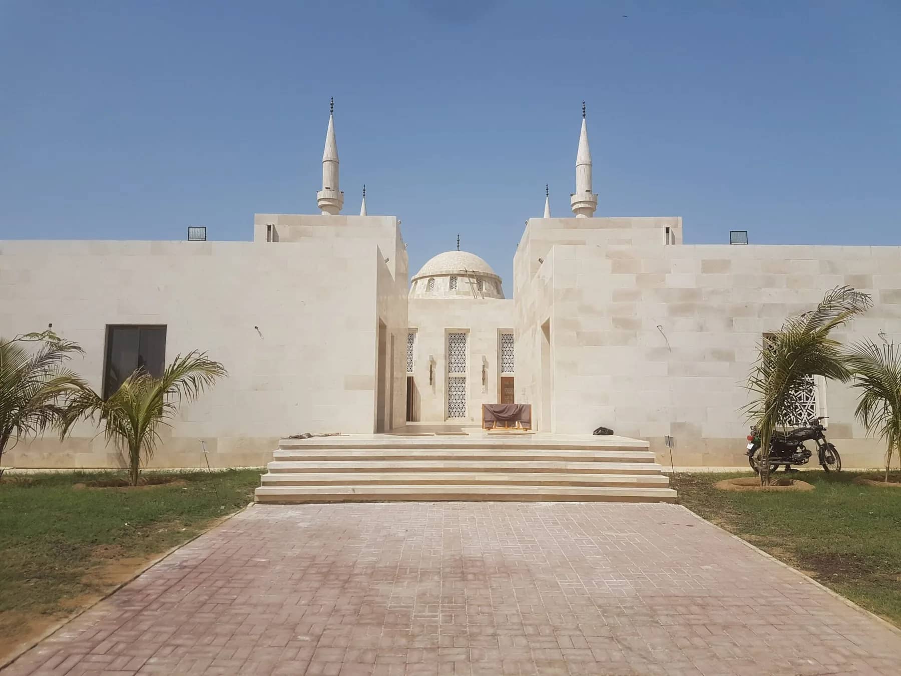 Naya Nazimabad Mosque clad in Botticino cream marble, minarets against a clear sky