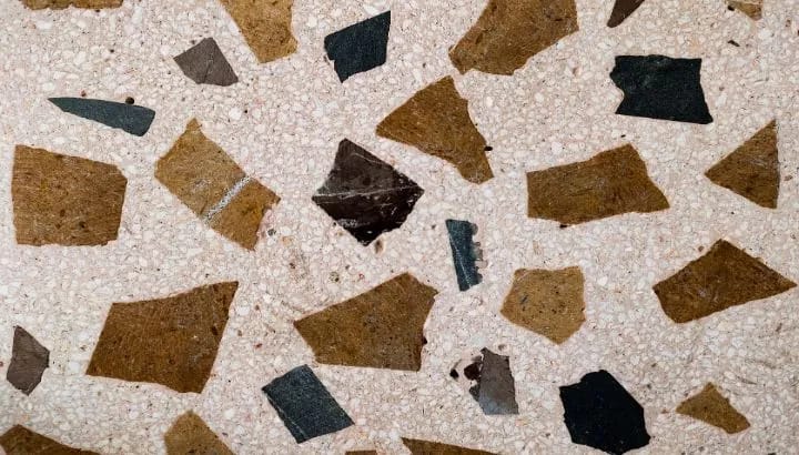 Large brown and black broken slab pieces set in a white matrix