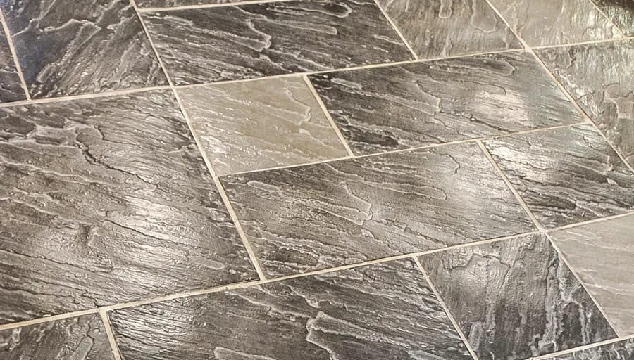 Grey brown riven concrete slabs laid on the diagonal with tight joints