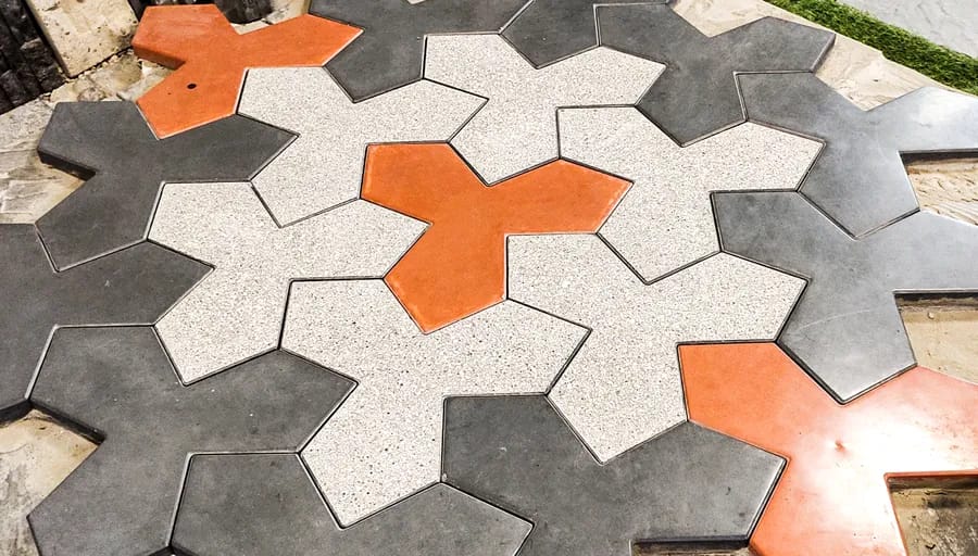 Interlocking jigsaw paving units in charcoal, white and orange