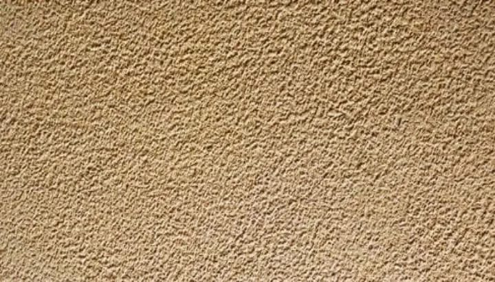 Bush hammered yellow sandstone, the face peened into a coarse grip