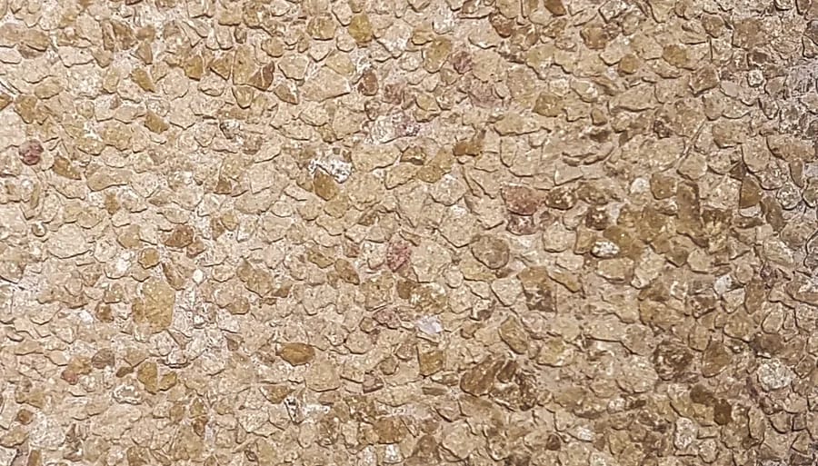 Washed terrazzo in fine golden ochre chip, close packed and even across the face