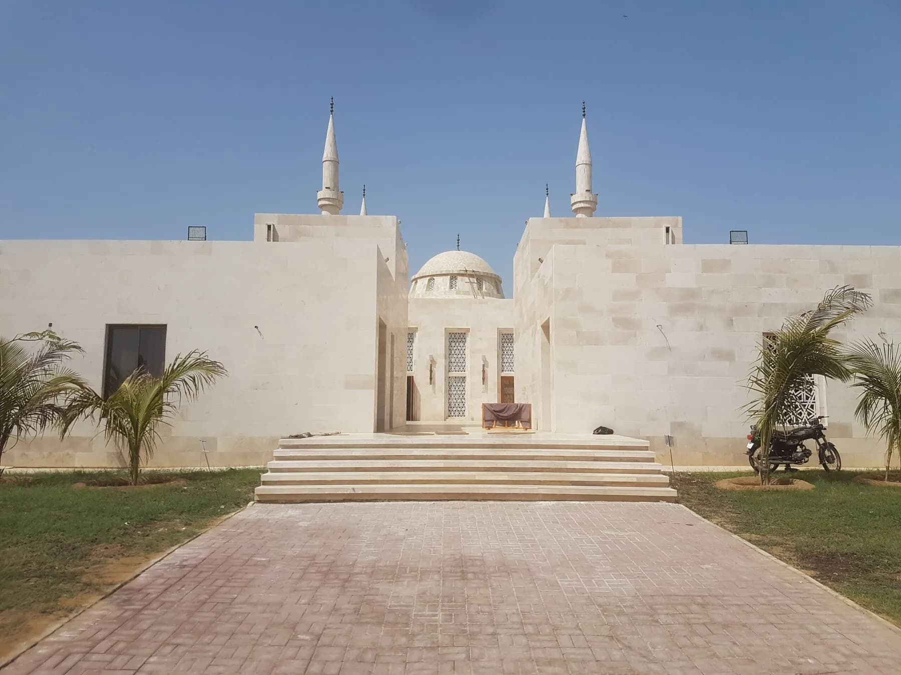 Naya Nazimabad Mosque clad in Botticino cream marble, minarets against a clear sky