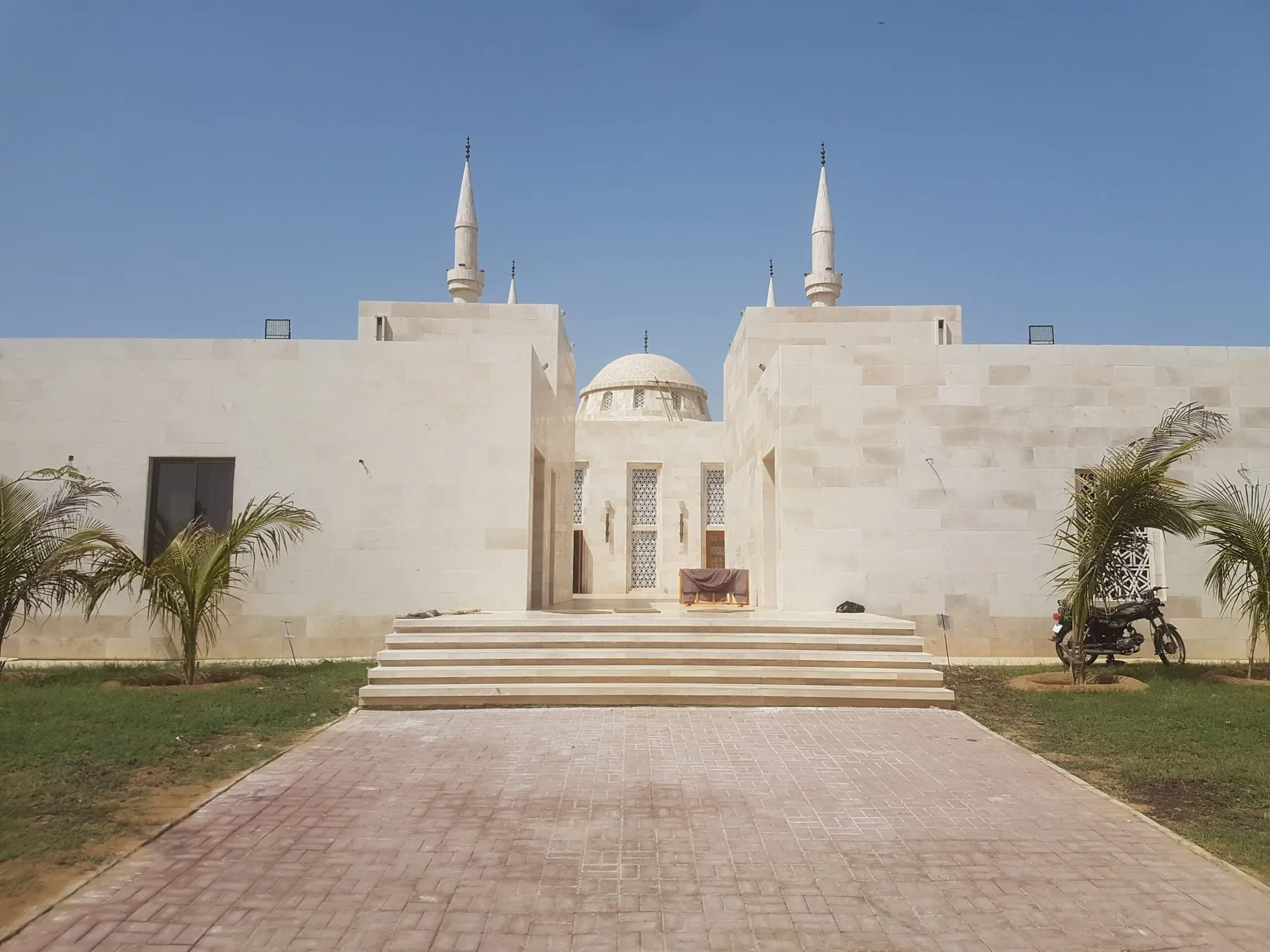 Naya Nazimabad Mosque clad in Botticino cream marble, minarets against a clear sky