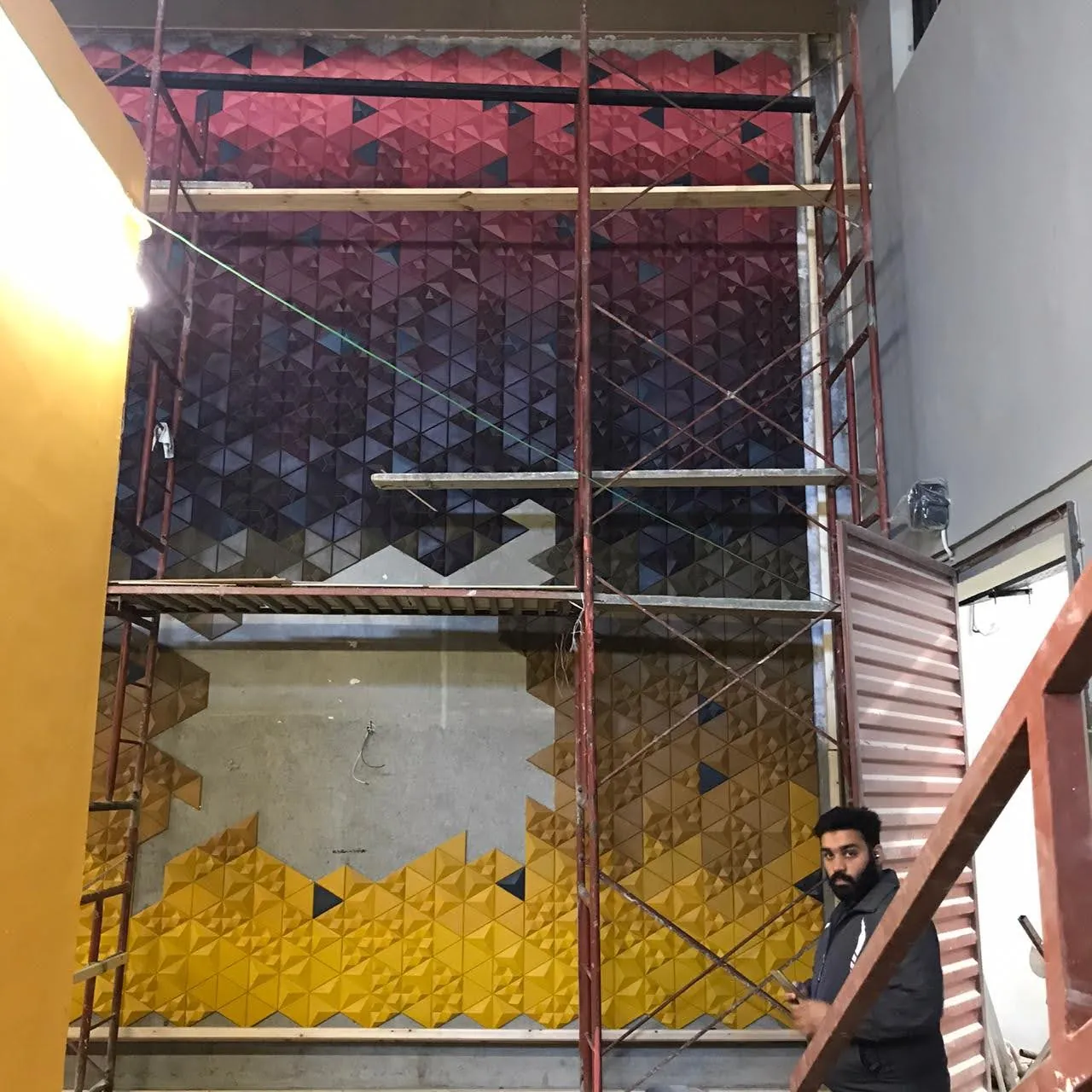 Mathlath 3D concrete tiles forming a triangulated relief wall at Optium Technologies