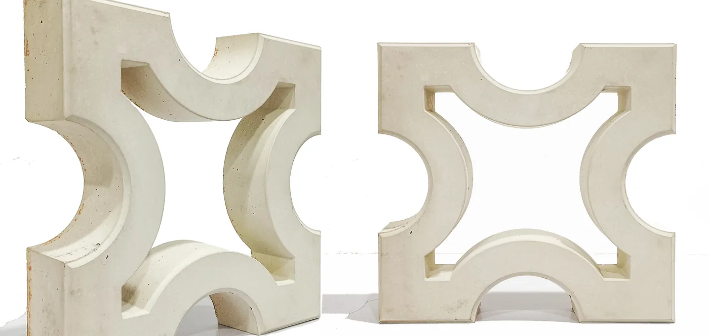 Two cement jali screen blocks, a square lattice cast solid in concrete