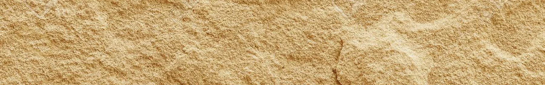 Sandstone with warm sedimentary banding across a naturally cleft face