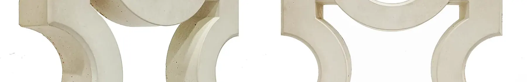 Cement jali screen blocks, square frames with a half circle scooped from each side, cast solid in concrete