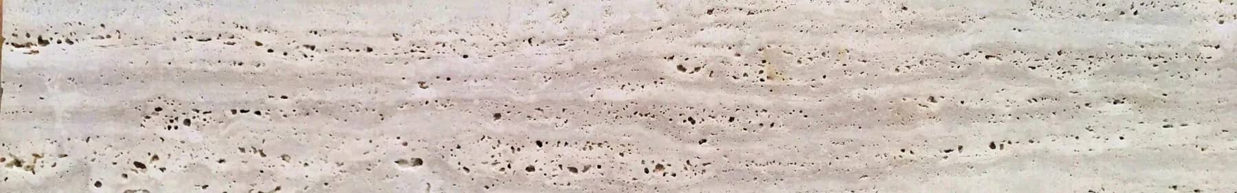 Travertine surface showing the characteristic open pore structure